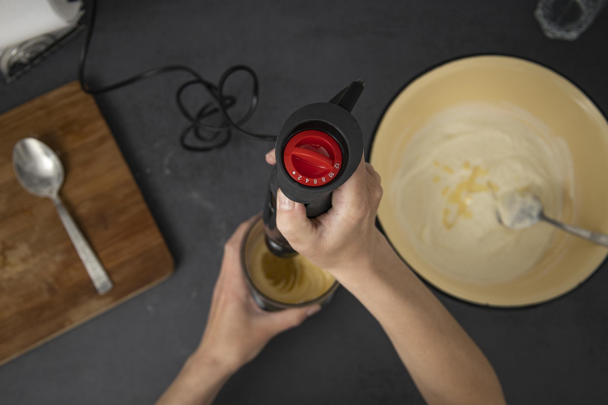 Close-up of hands finishing sauce